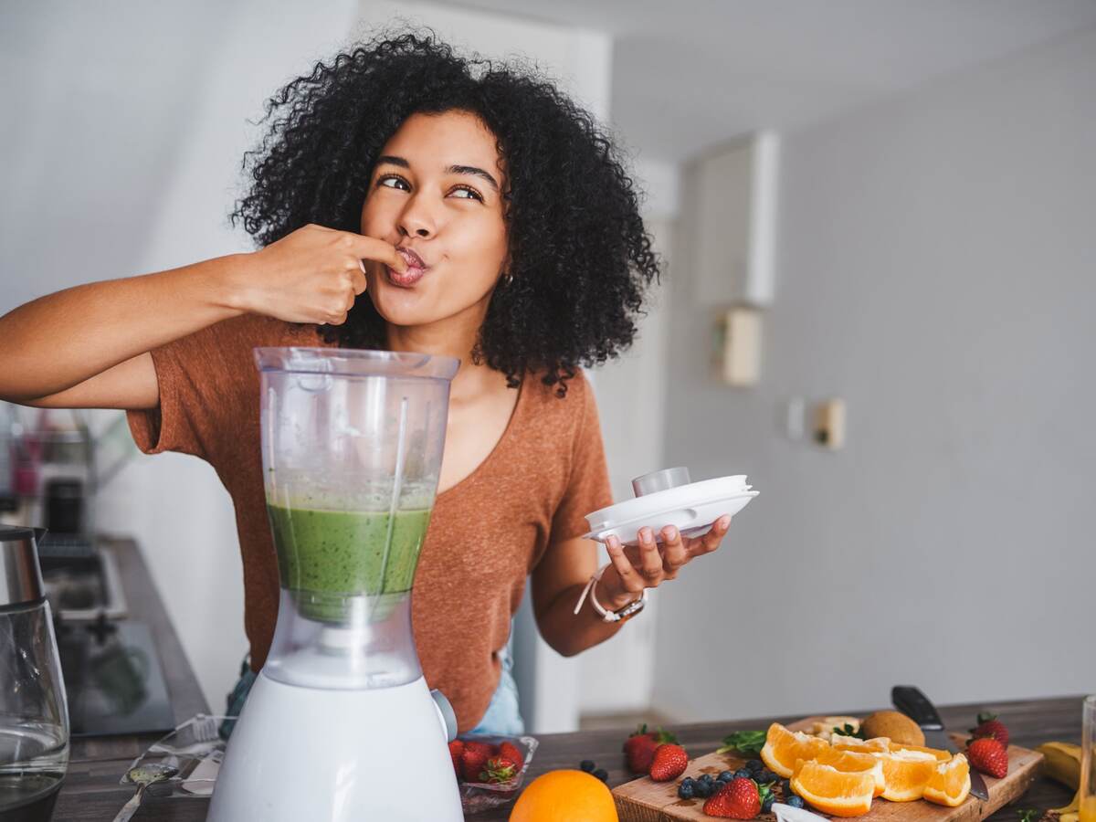 Woman with kitchen appliance.