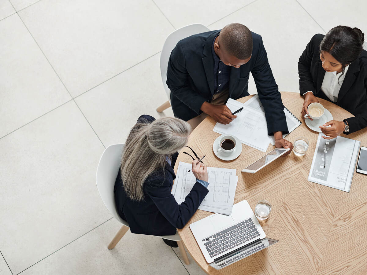 Overhead view of three business professionals having a meeting