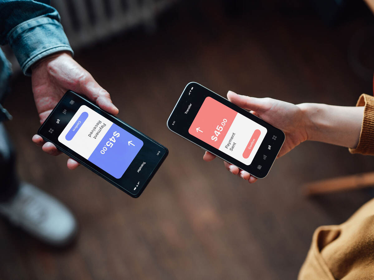 Closeup of two people managing online banking with smart phone