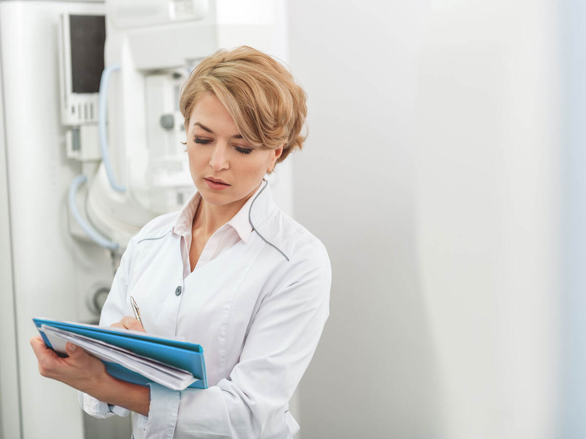 Medical advisor taking notes in a hospital