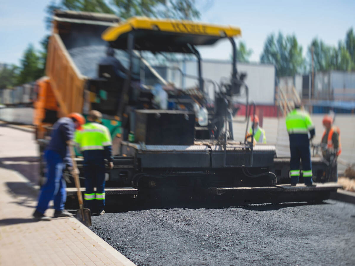 A crew laying asphalt