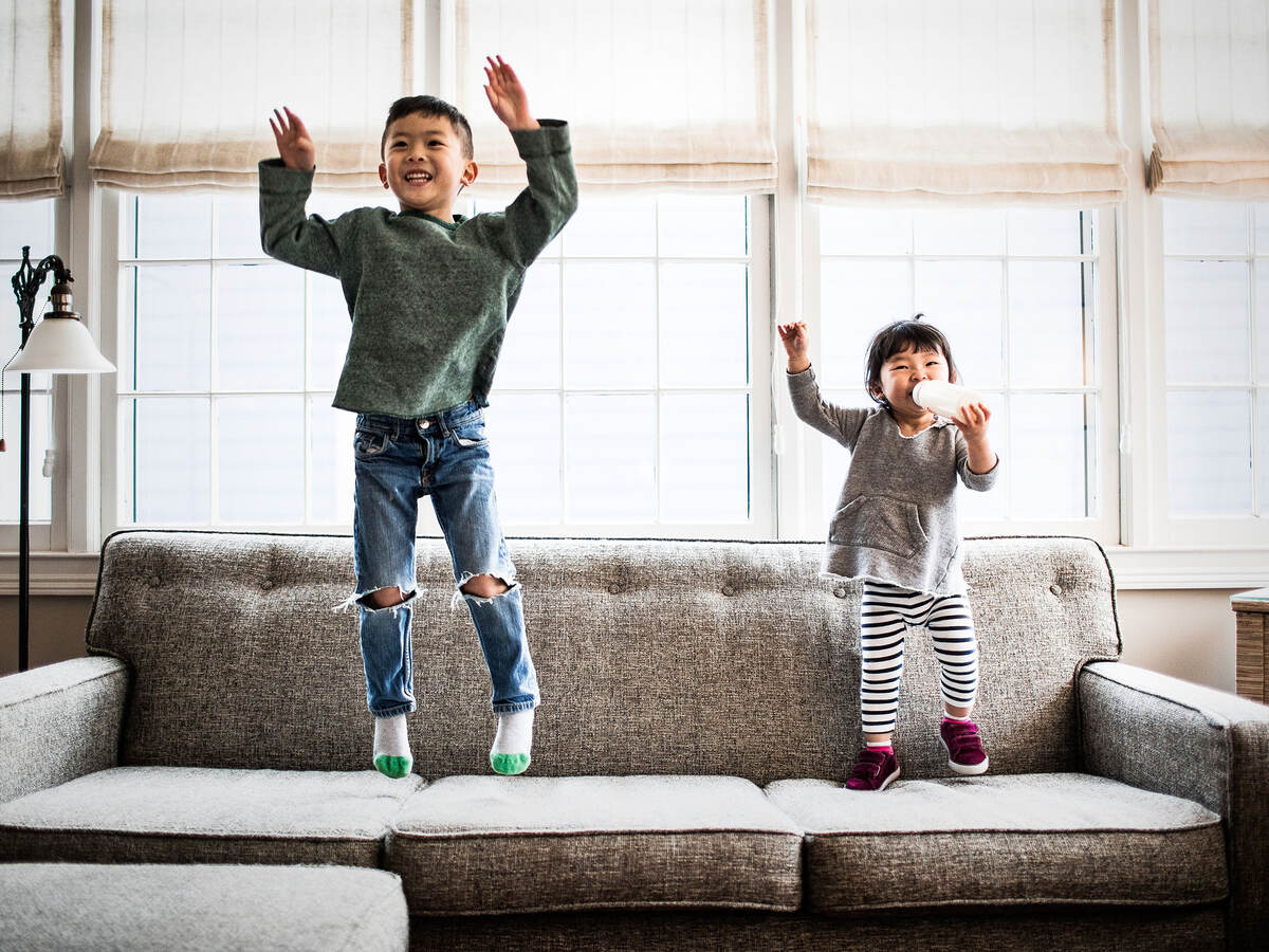 kids jumping on couch at home