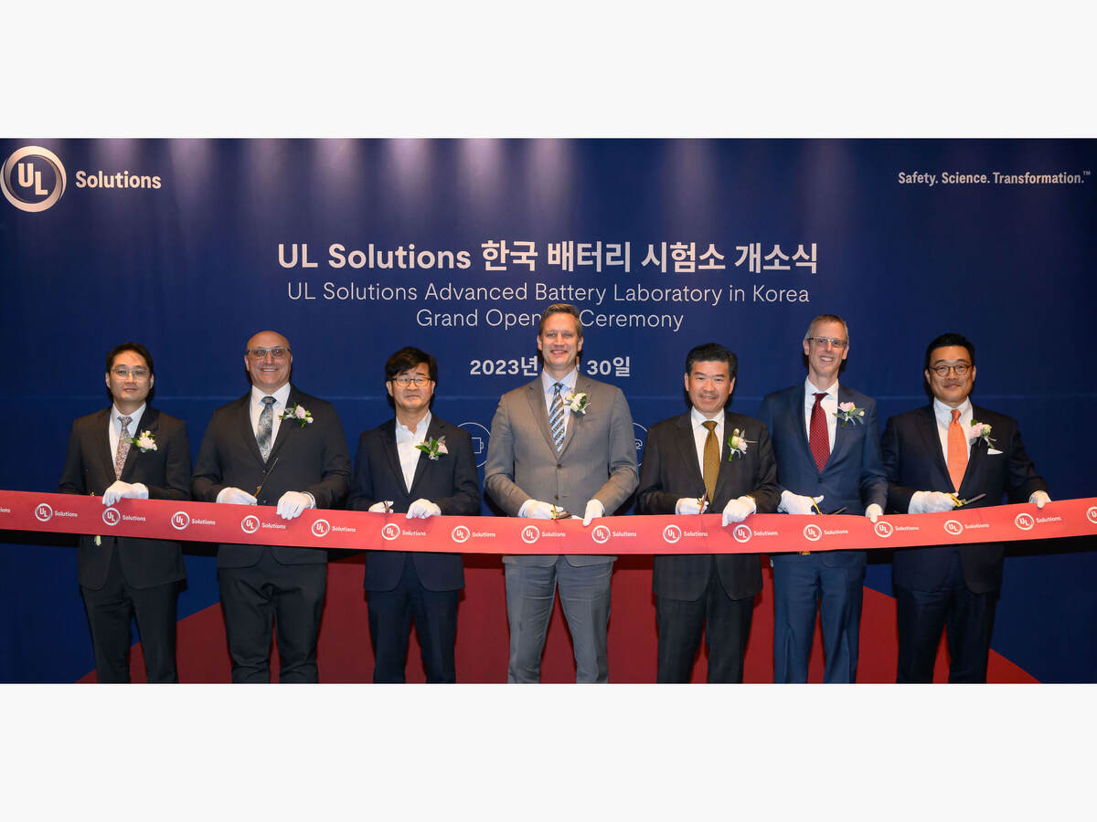 Seven people cutting a ribbon at the UL Solutions Korea laboratory ribbon cutting ceremony