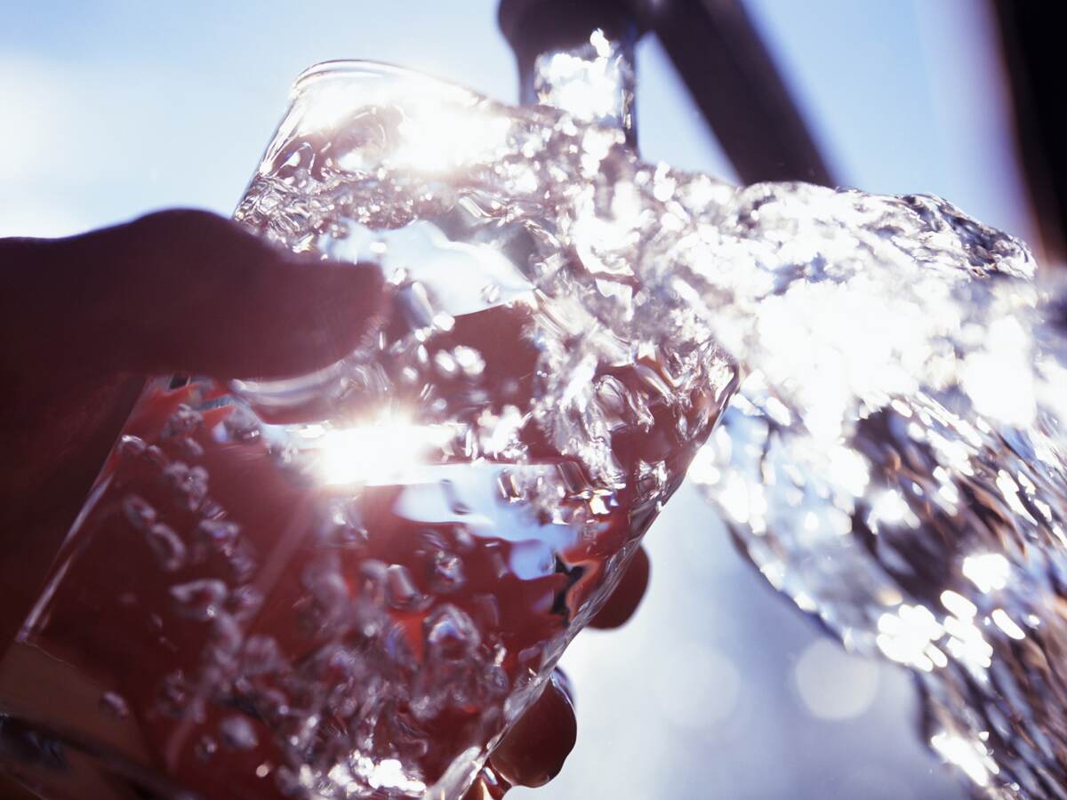 Filling glass with water.