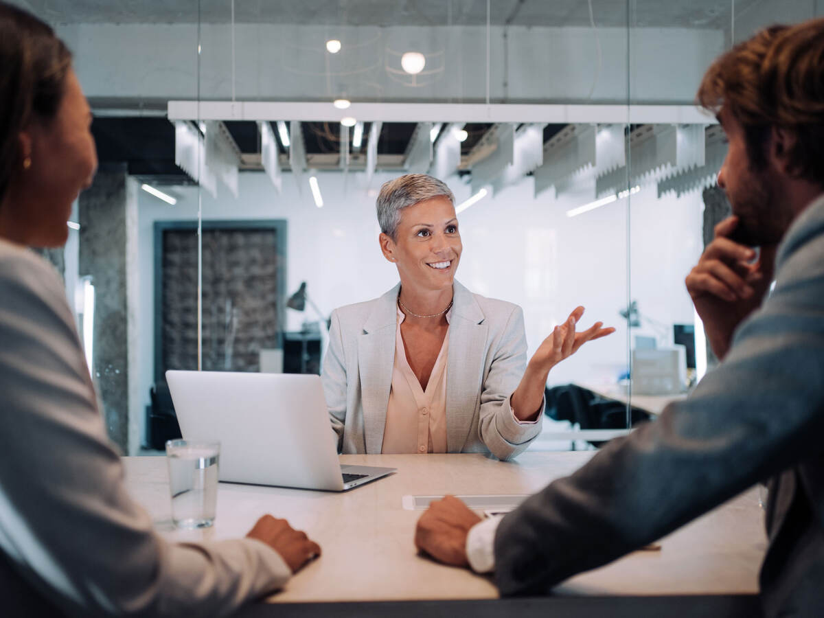 Three business people at a table having a meeting