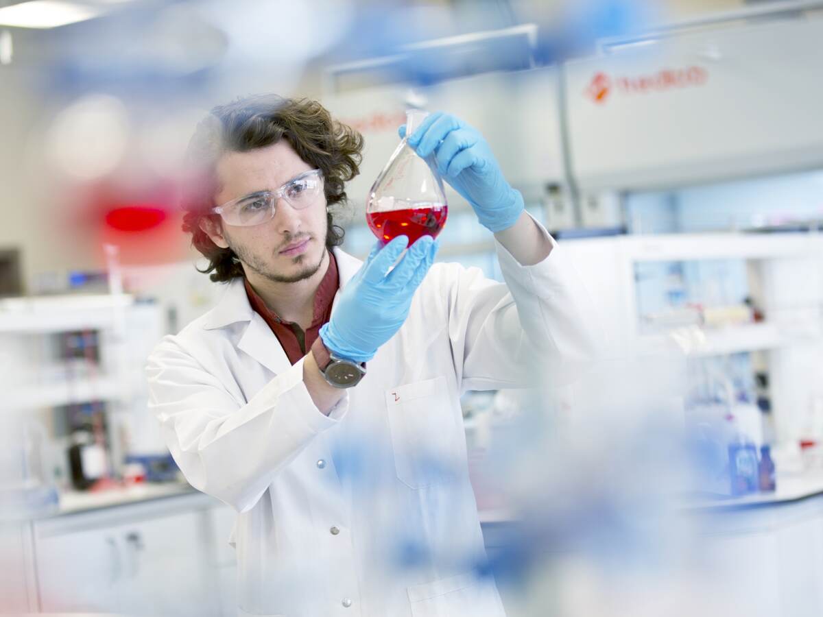 Chemistry research student working in laboratory.