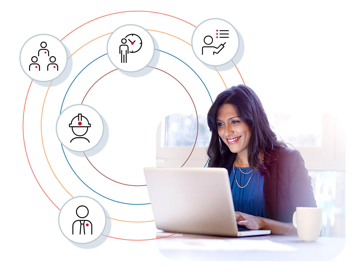 Business professional smiling while using a laptop as icons surround her
