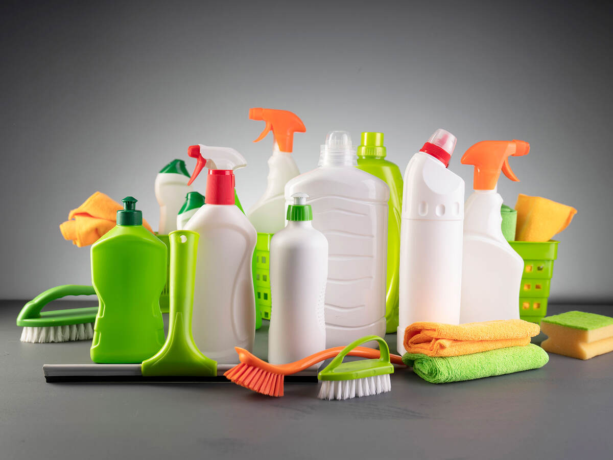 several cleaning products on a gray background