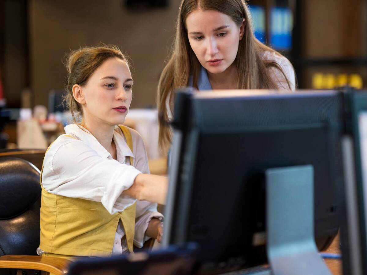 Two business colleagues collaborating in front of a computer