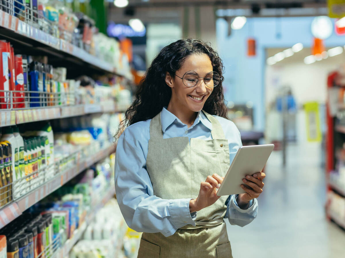 Store clerk using a tablet to do inventory
