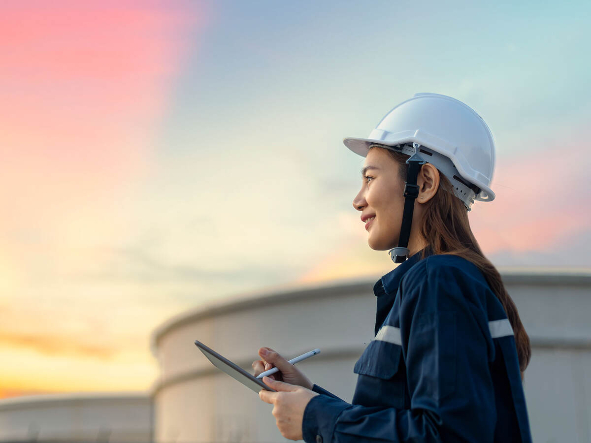 Petroleum oil refinery engineer worker with personal safety equipment PPE to inspection follow checklist by tablet