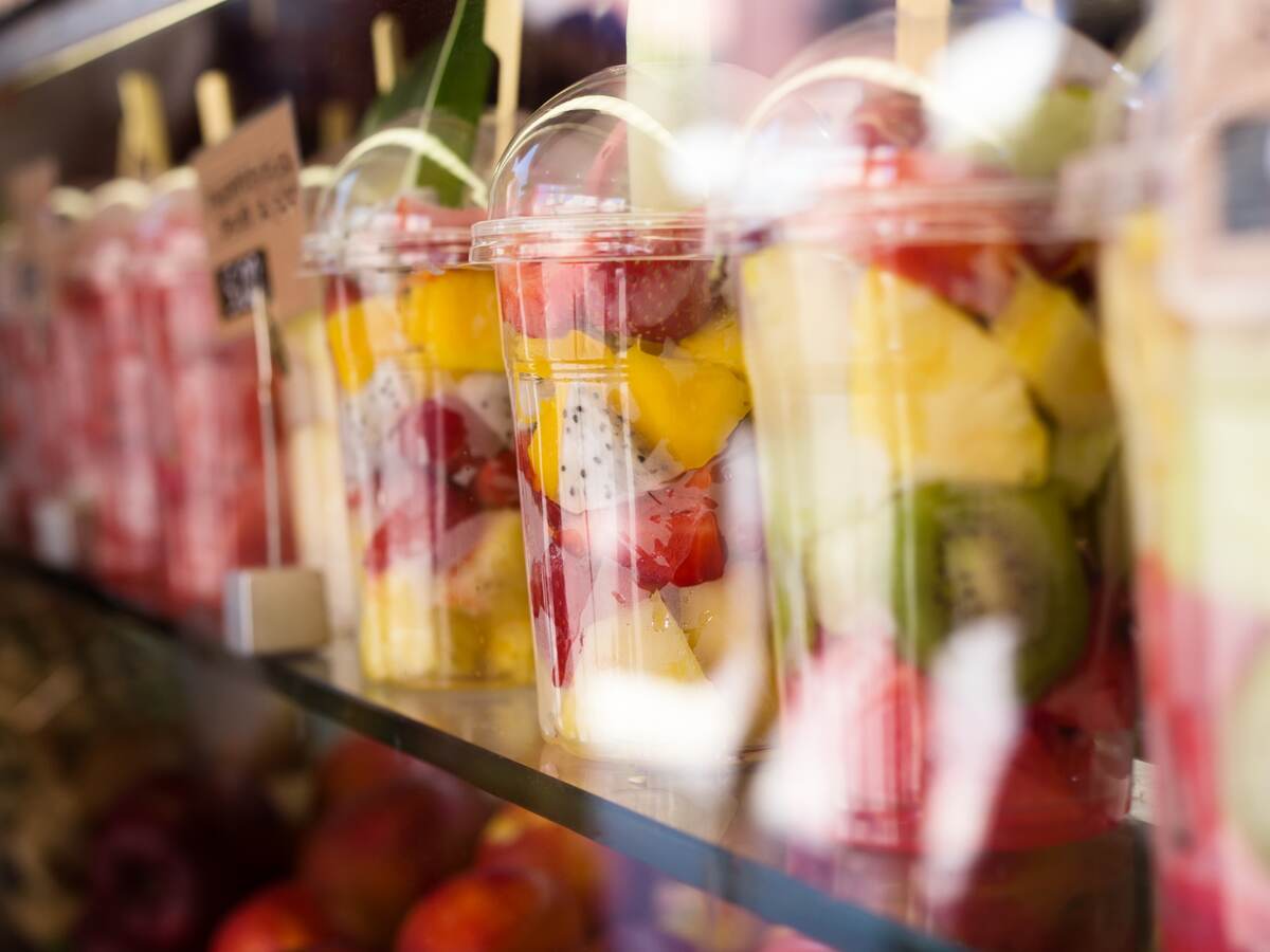 Fresh colorful fruit salad in plastic packaging.