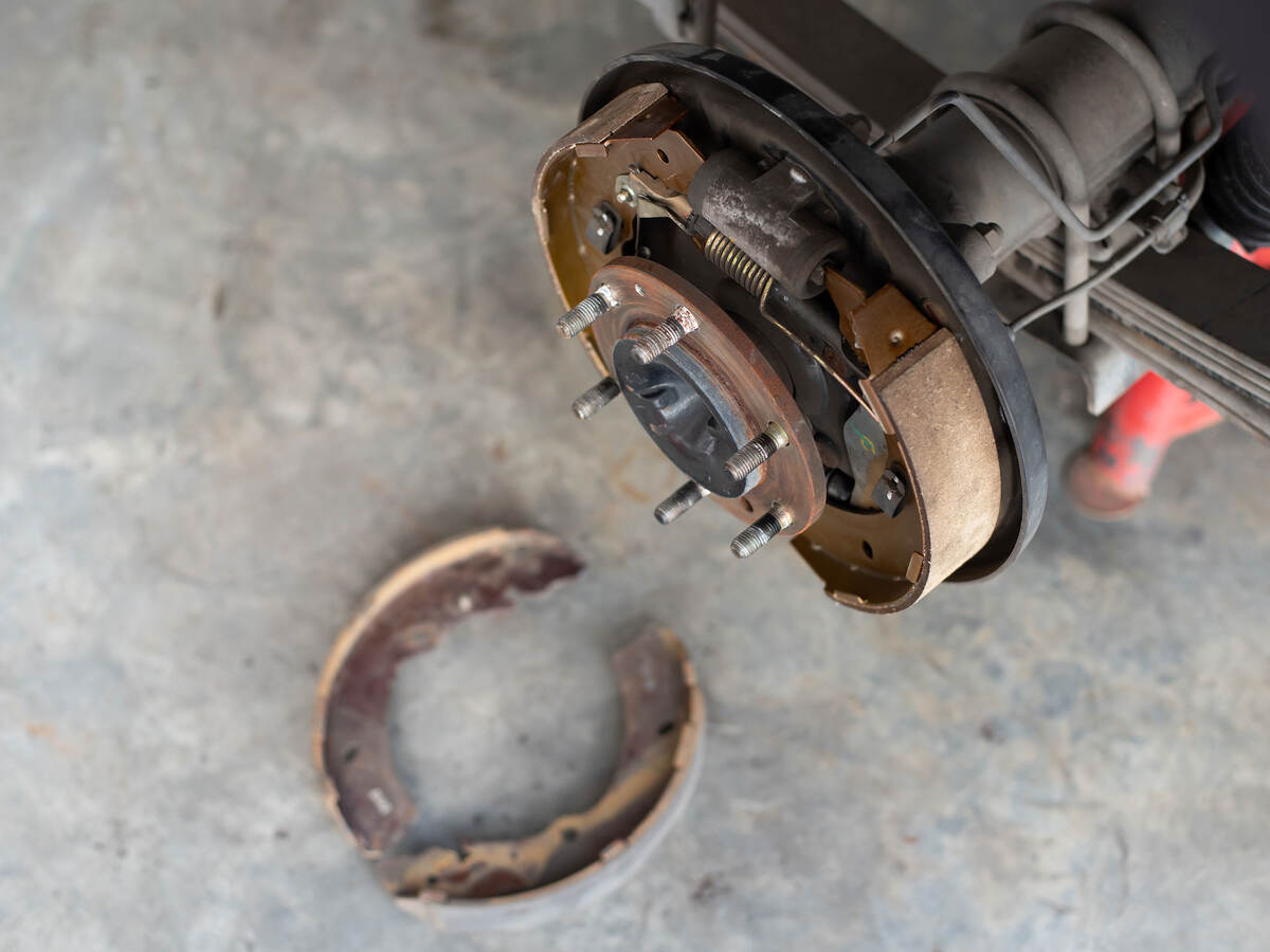 Drum brake and asbestos brake pads at car garage