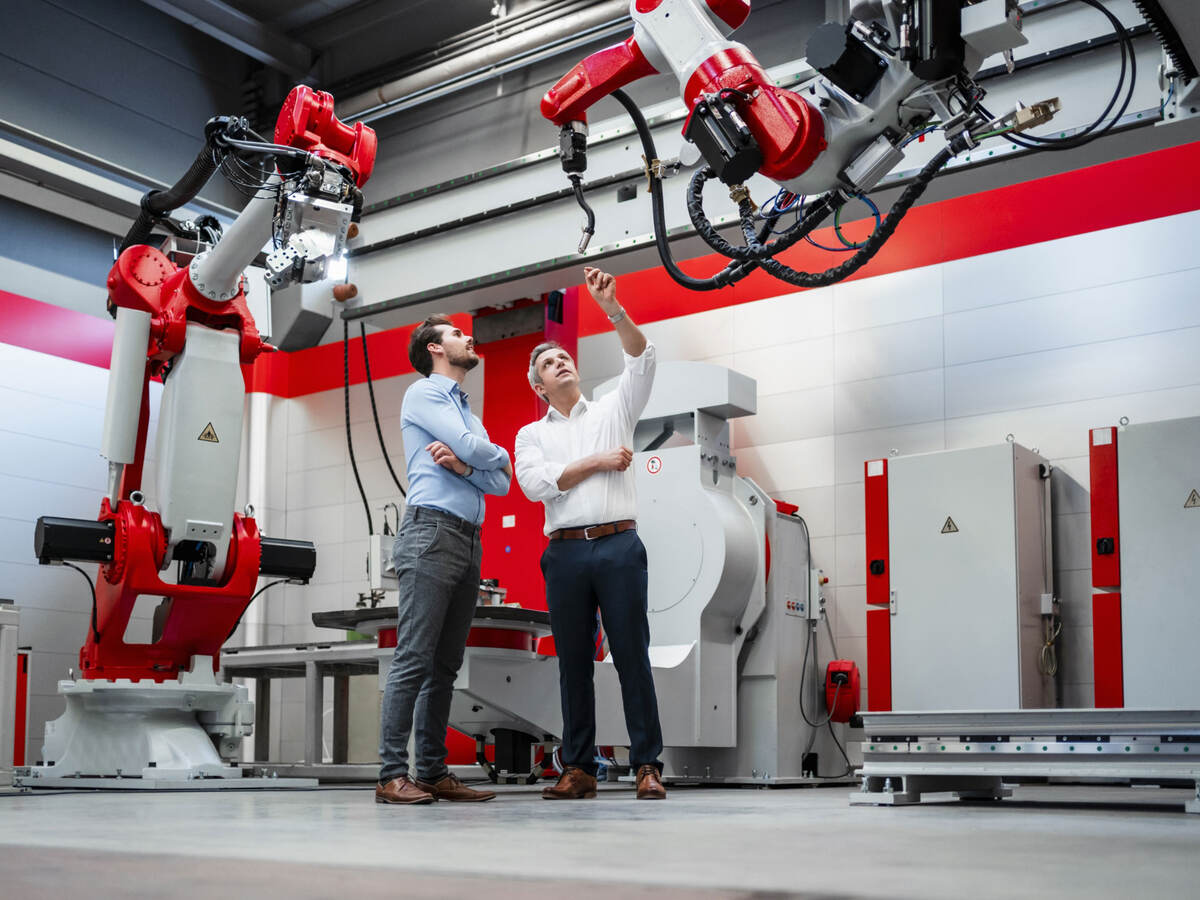 An engineer explaining a robotic arm
