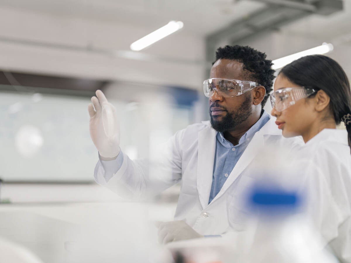 Two lab scientists reviewing a sample together