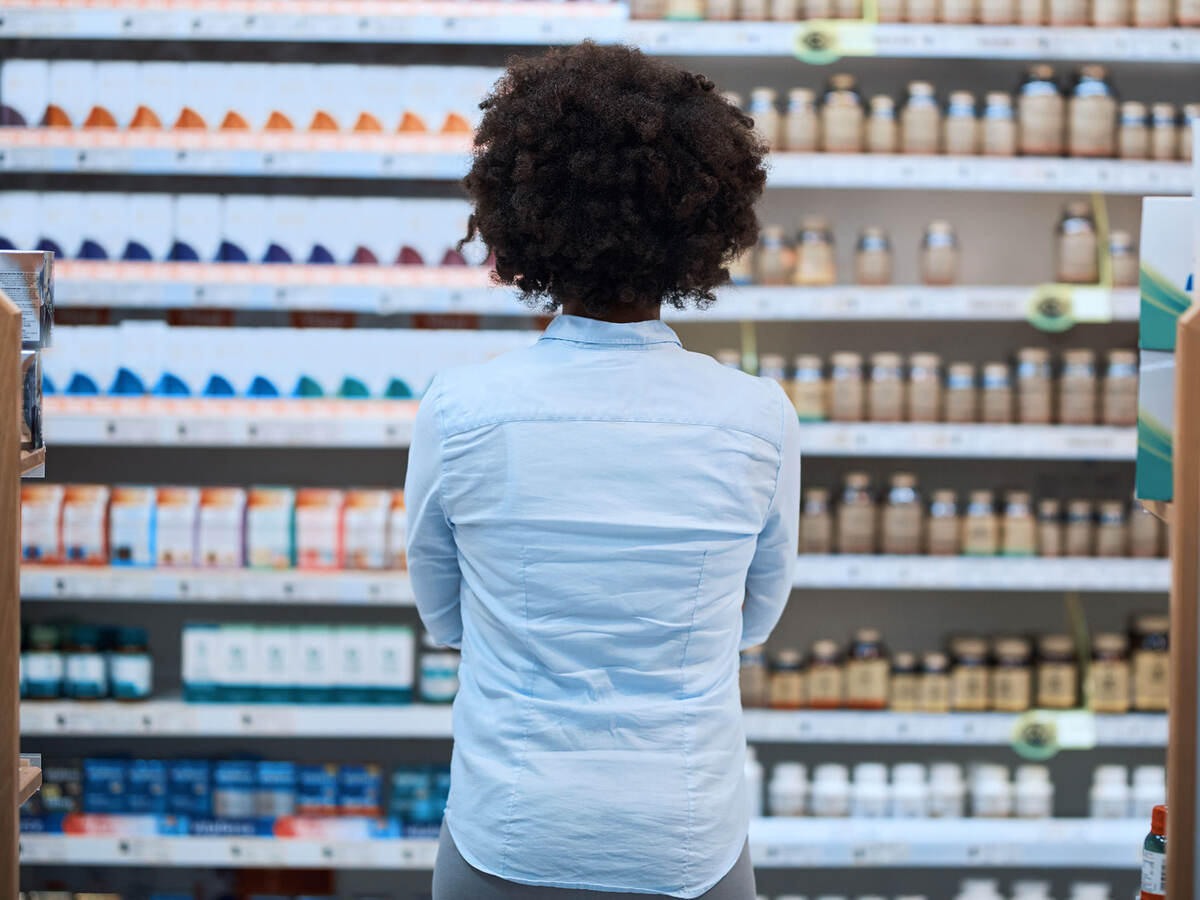 a person looking at a shelves of many health products