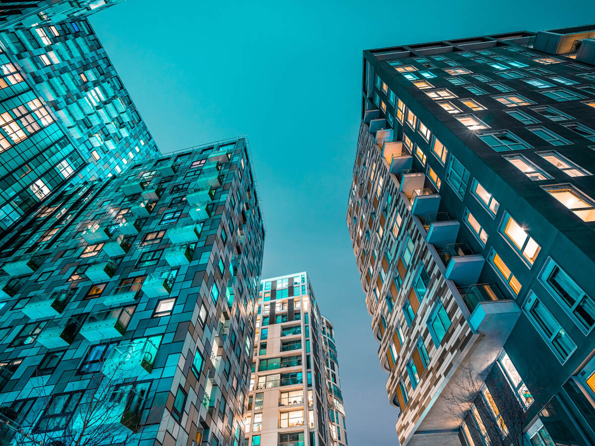 Lights in a high-rise apartment building at dusk