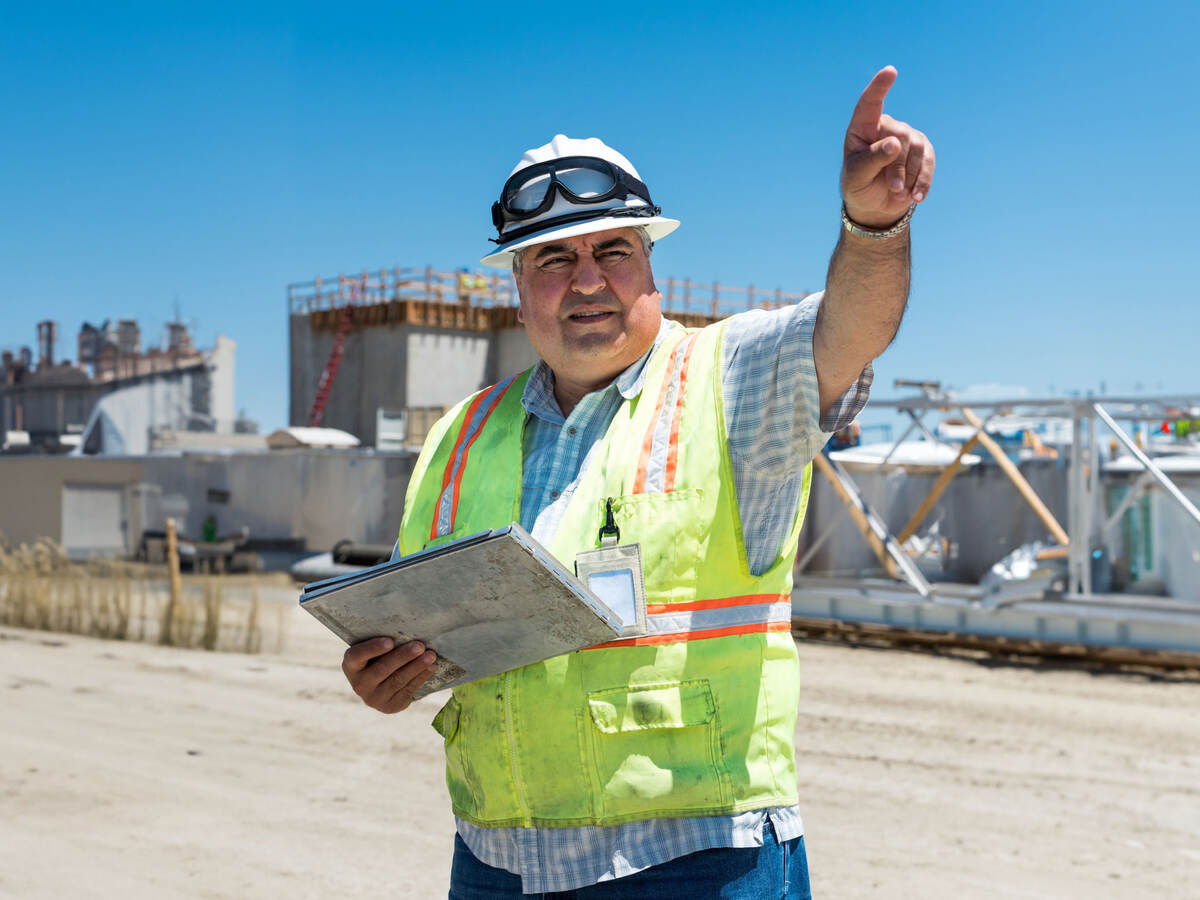 A construction worker pointing