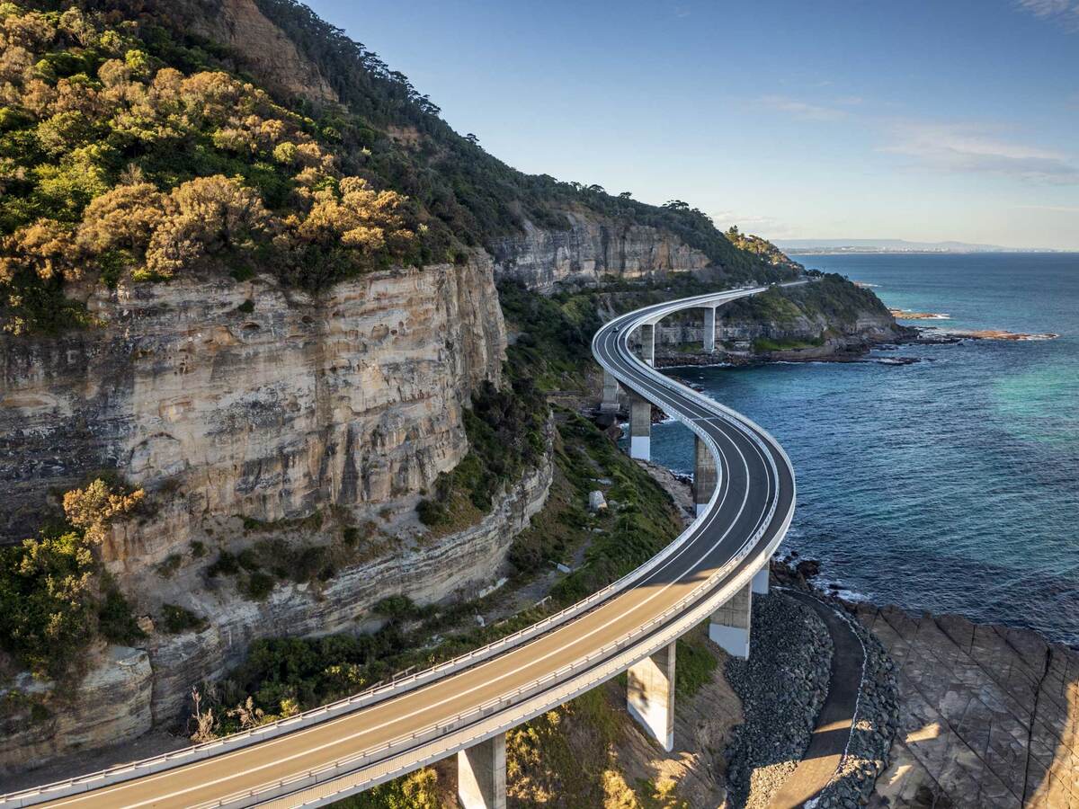 A winding costal road alongside a steep mountain