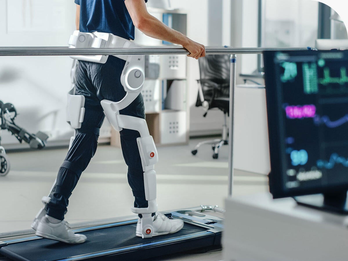 Patient with injury walks on a treadmill while wearing advanced robotic exoskeleton legs