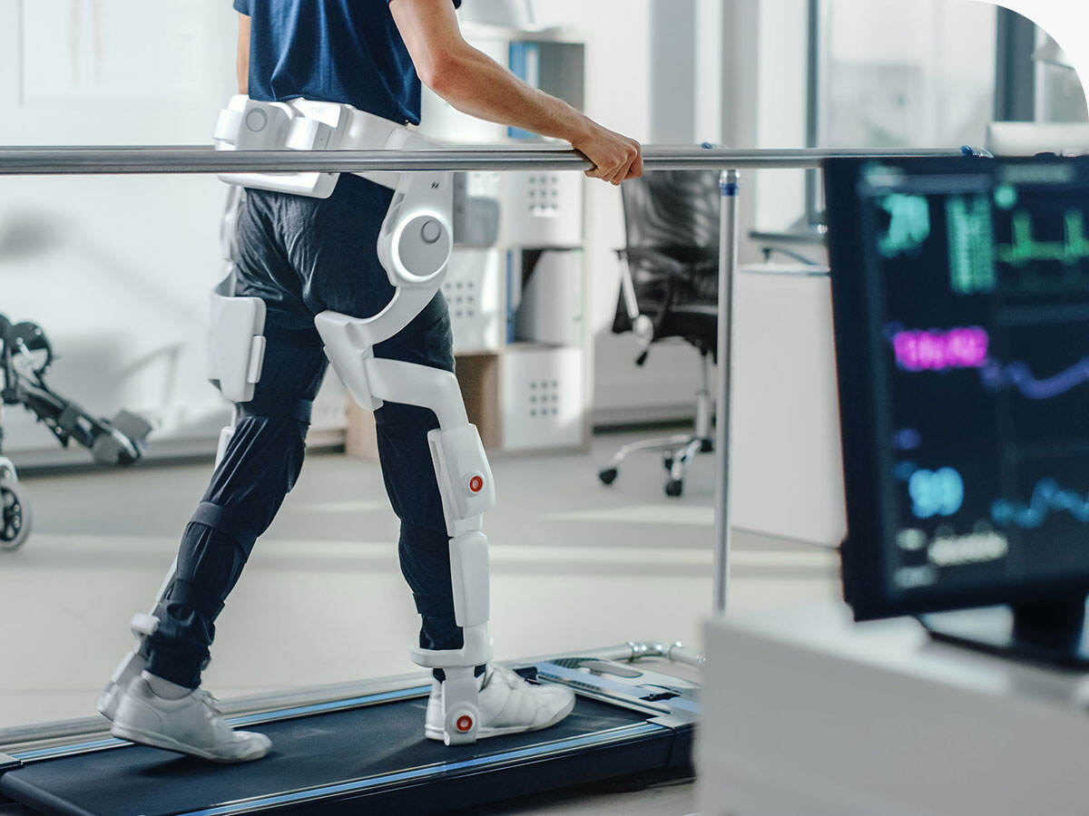 Patient with injury walks on a treadmill while wearing advanced robotic exoskeleton legs