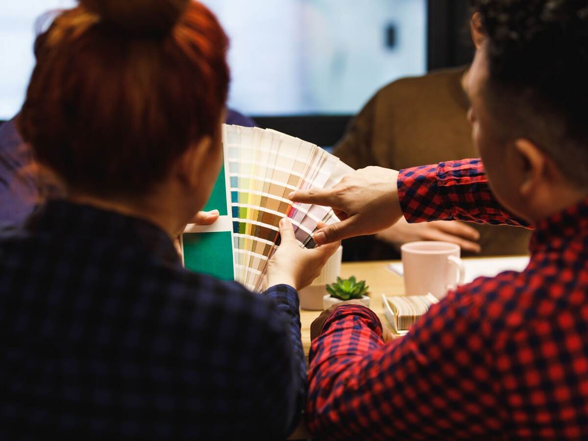 Two kids looking at color swatches