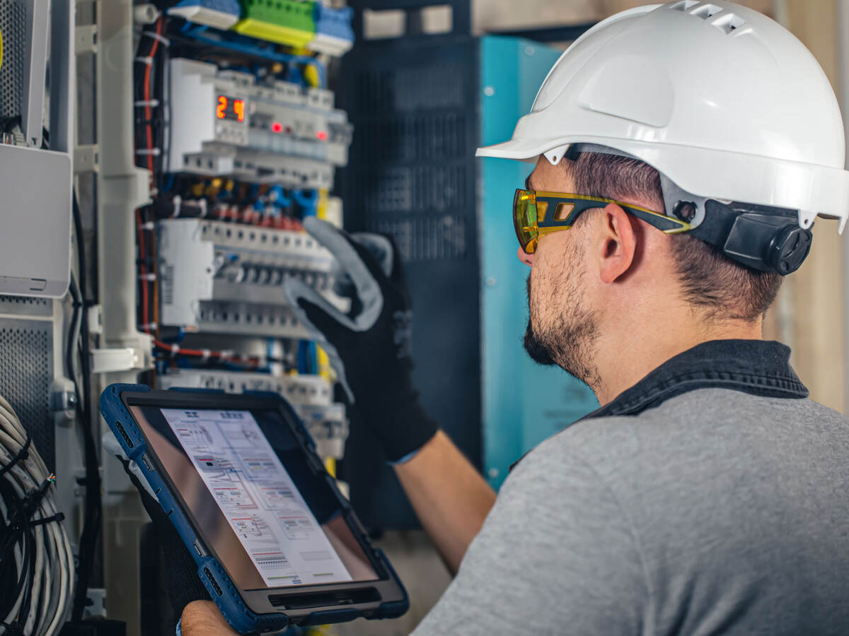 Electrical technician at a switchboard