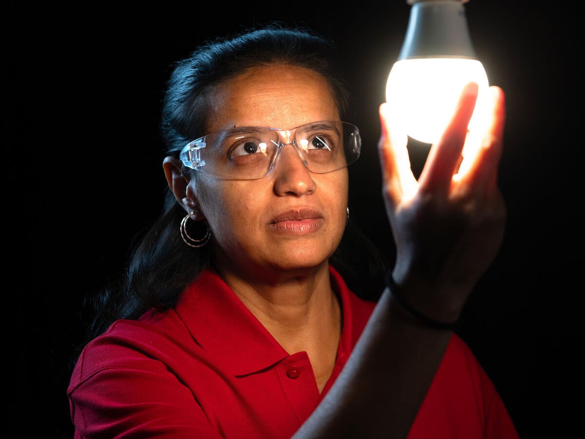 A person inspecting a lightbulb