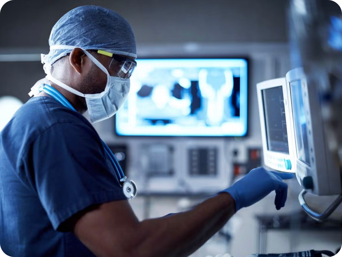 doctor with surgical mask using a medical device