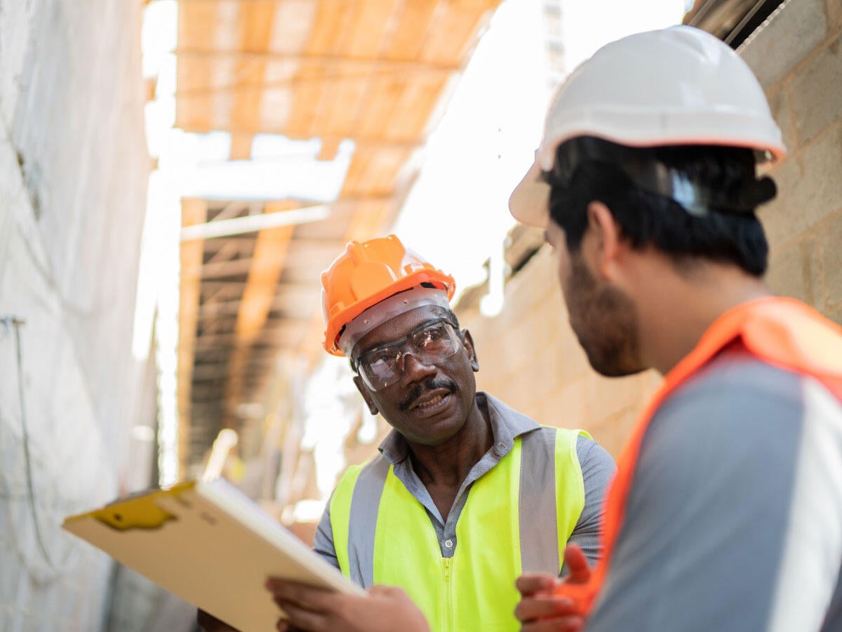 Two construction workers talking