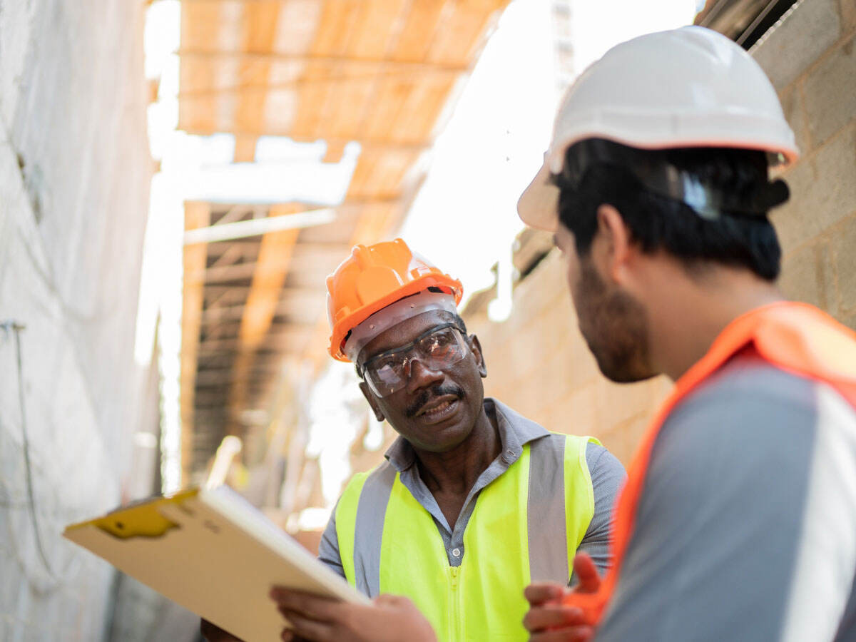 Two construction workers talking