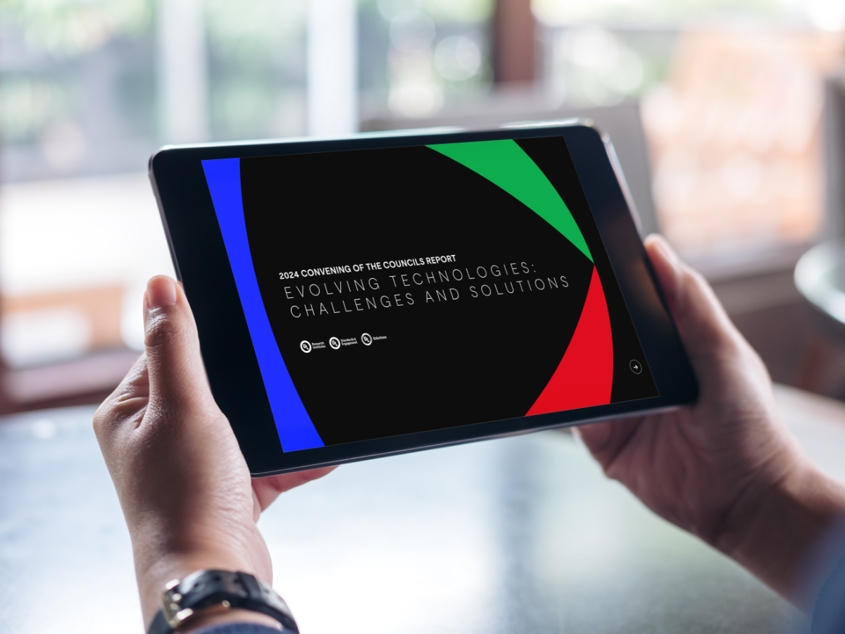 Person reading the 2024 Convening of the Councils report on a tablet