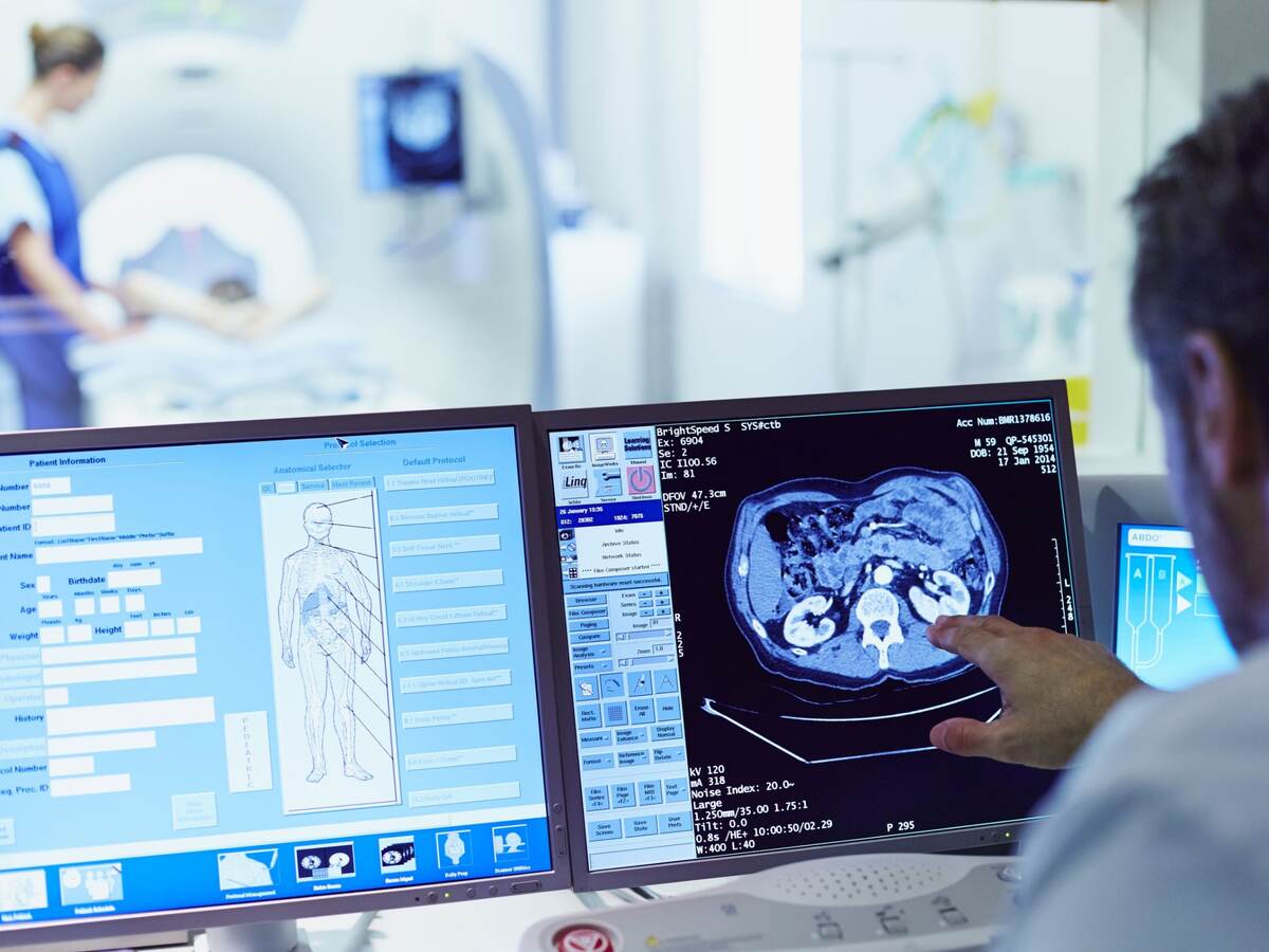 Doctor running ct scan from control room