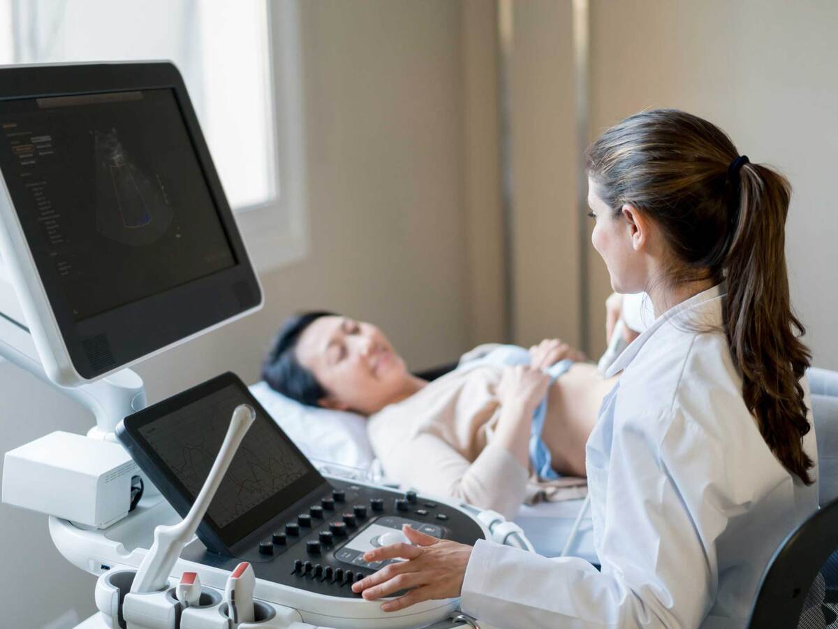 A doctor conducting a sonogram on a pregnant patient