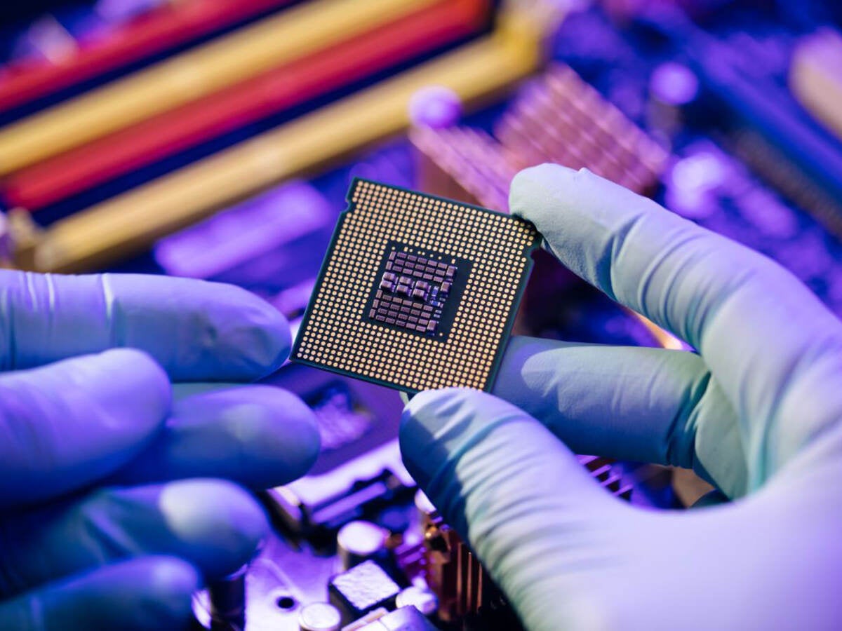 hands holding a computer chip