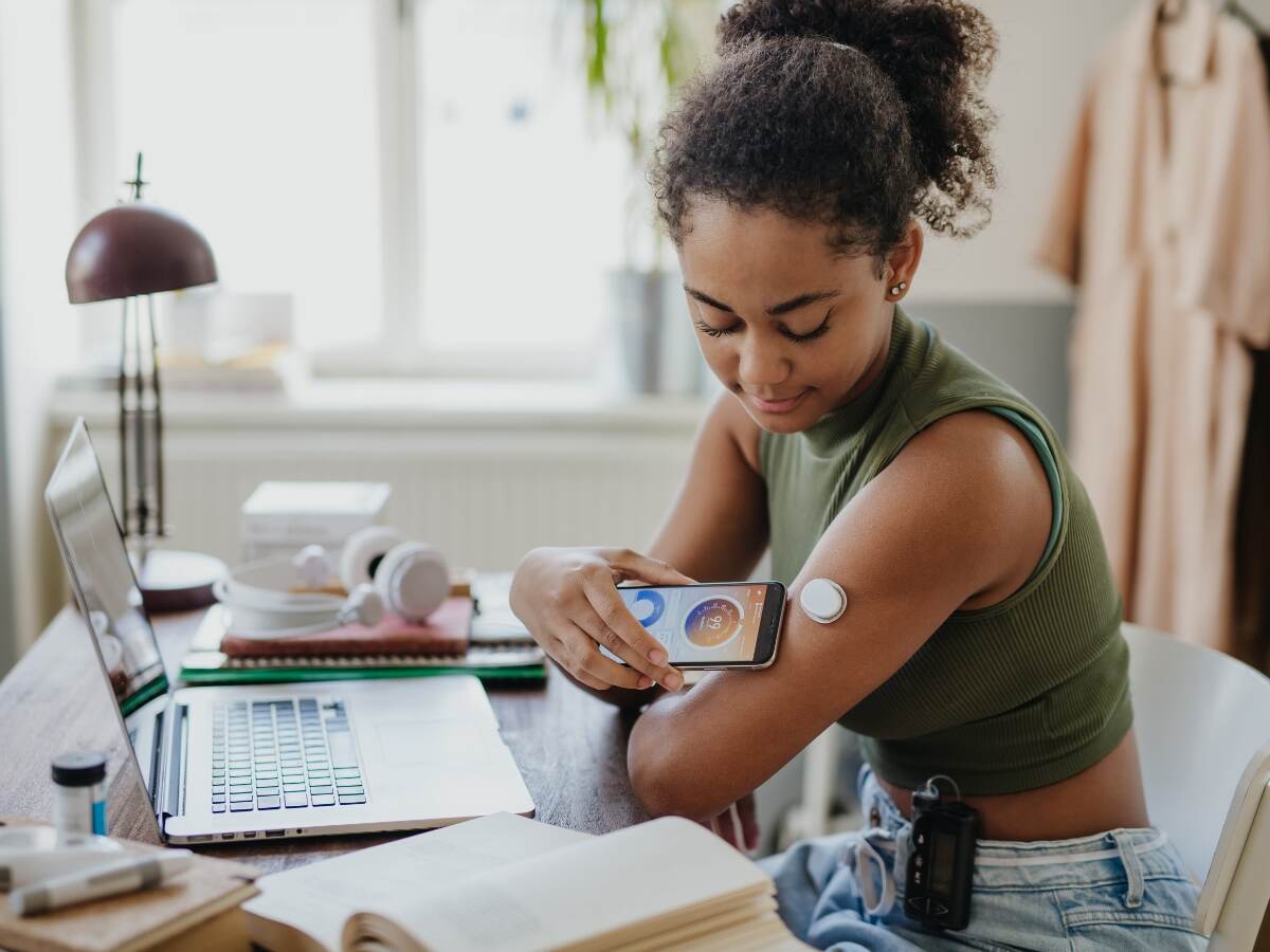 girl checking medical device on her phone