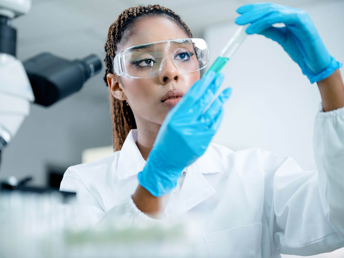 Medical researcher analyzing a sample while meeting GMP requirements in clinical studies