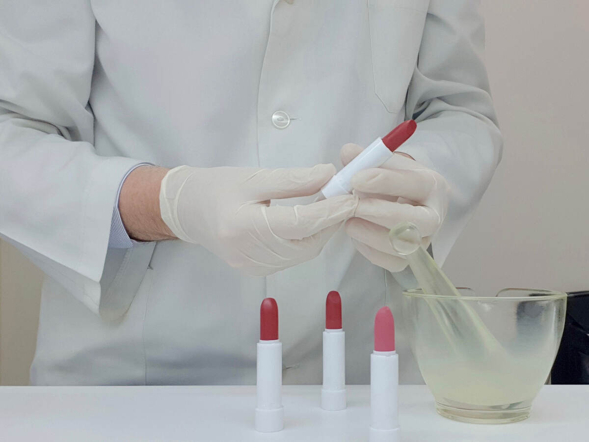 A laboratory technician testing lipsticks
