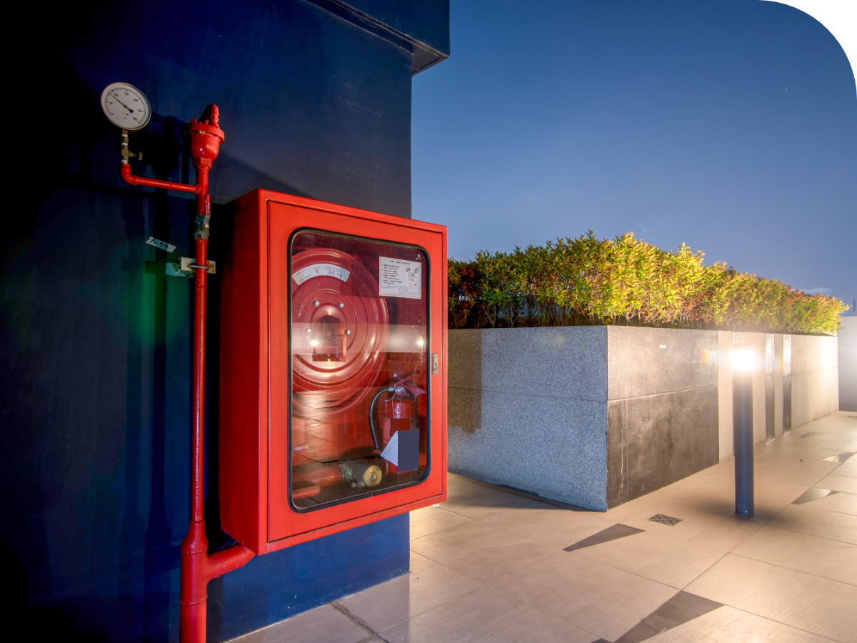 Fire prevention system on blue wall across from raised garden
