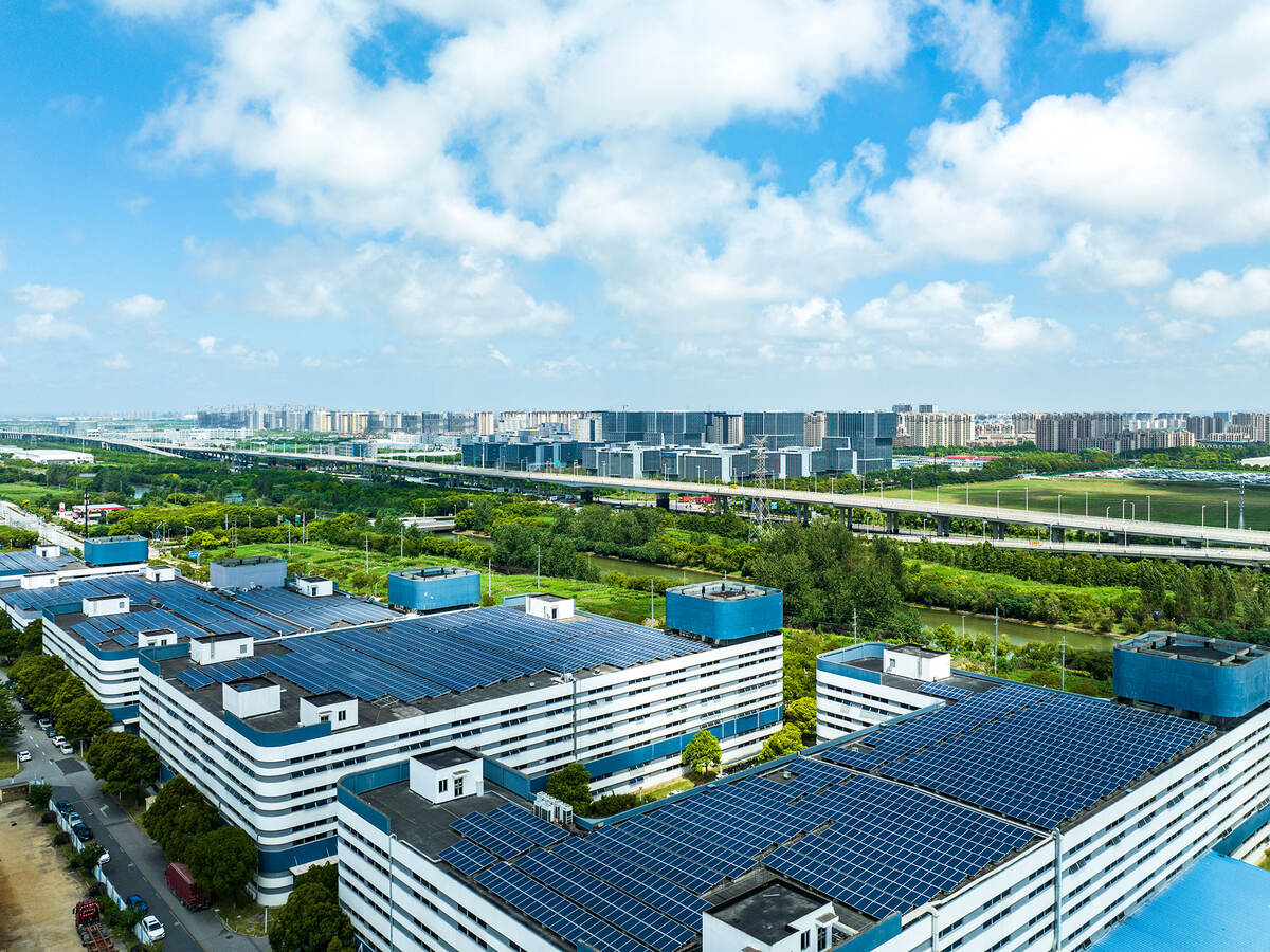 Aerial view of solar panels installed on factory rooftop