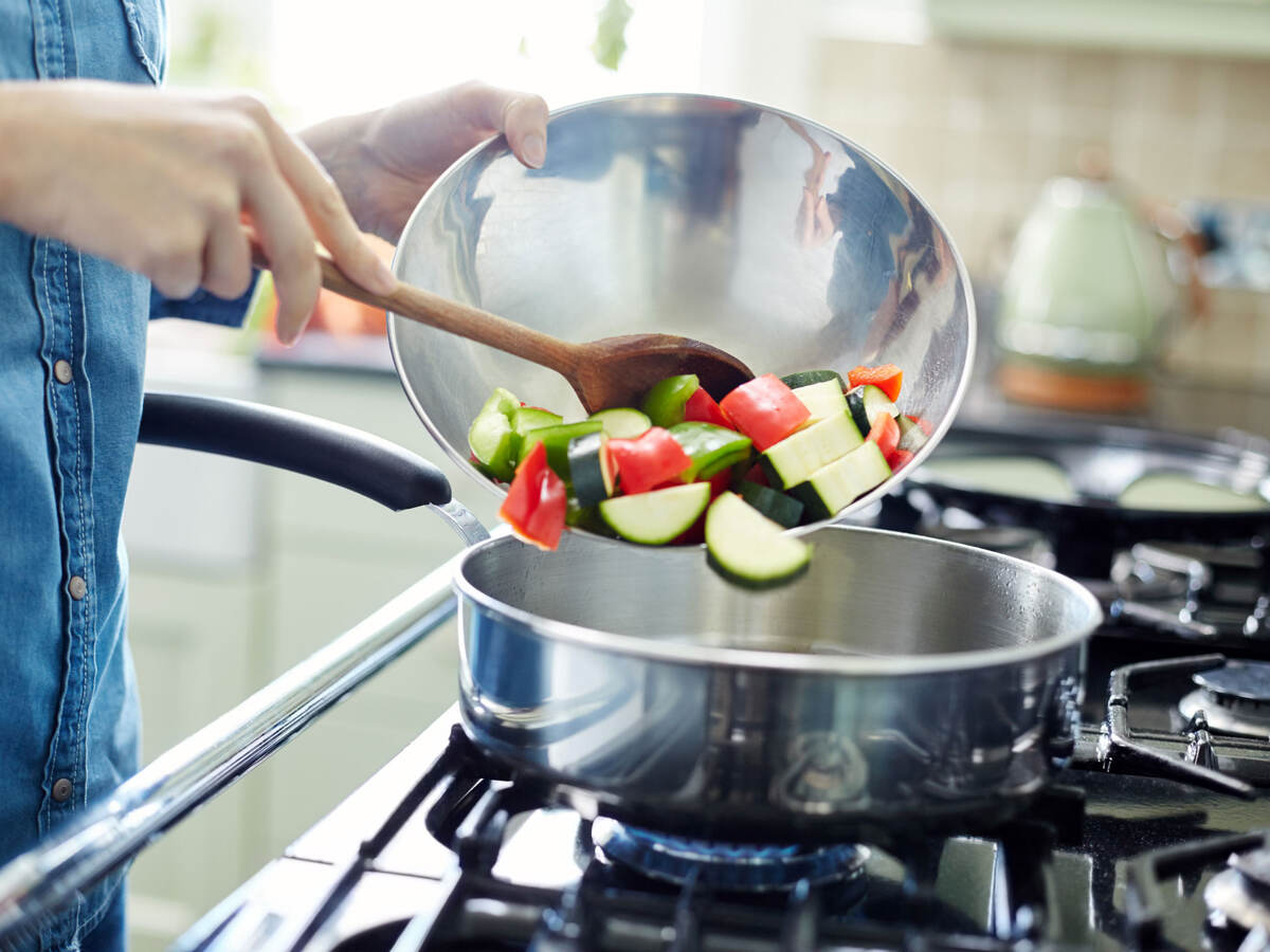 A person cooking colorful vegetables