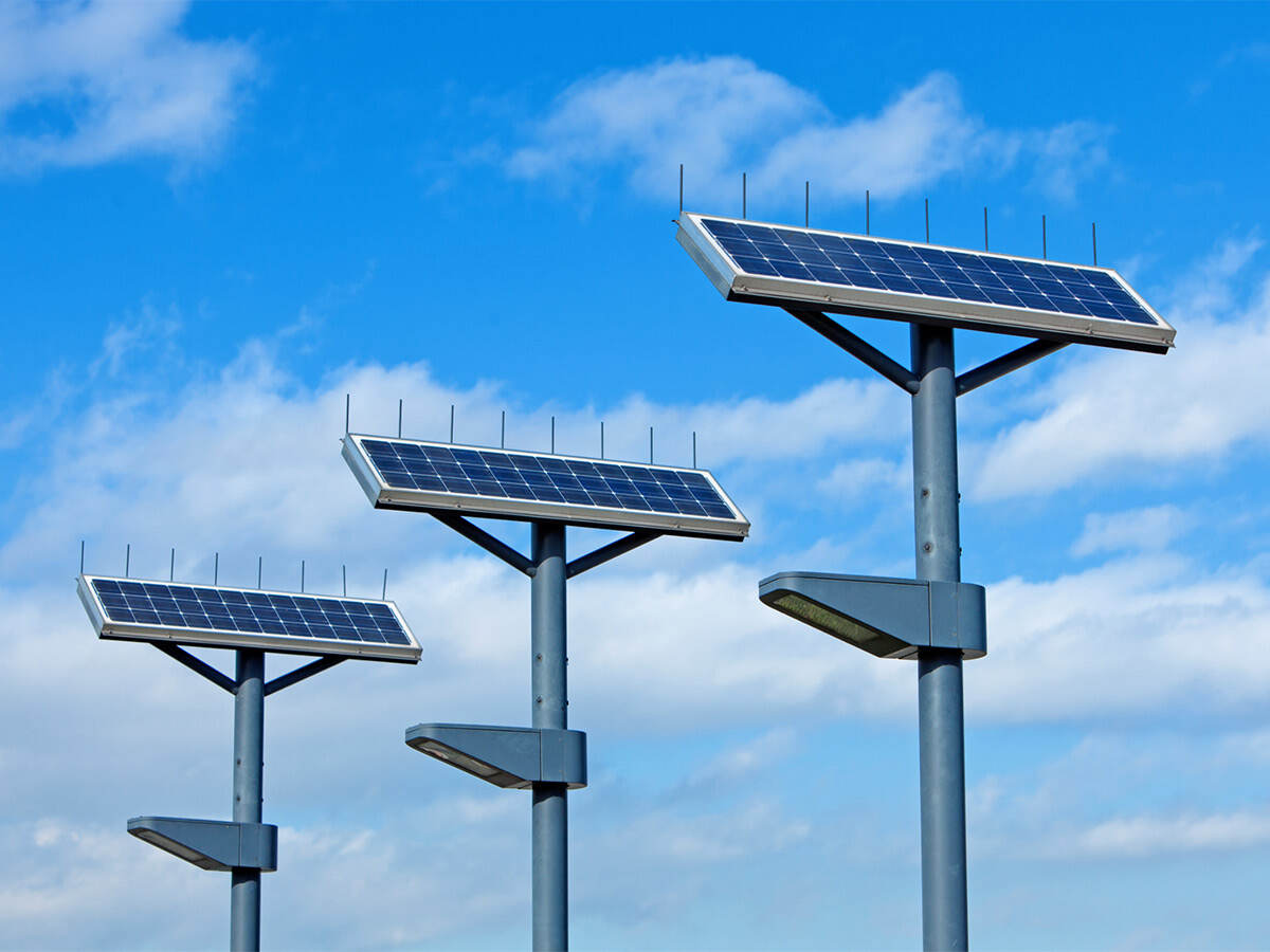 solar powered street lights shot against a blue sky