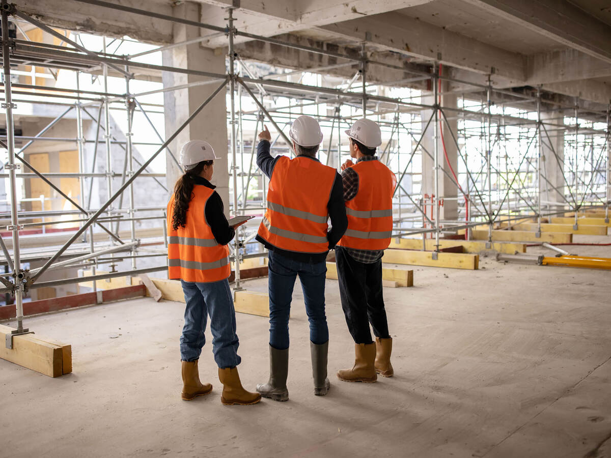Three construction engineers inspecting work