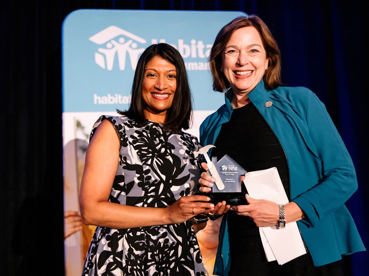 Jennifer Scanlon, president and CEO of UL Solutions (right), accepts the 2025 Habitat Hero Award on behalf of UL Solutions and poses with Meena Beyers, vice president of business and community development at Nicor Gas, during a June 12 event in Chicago.