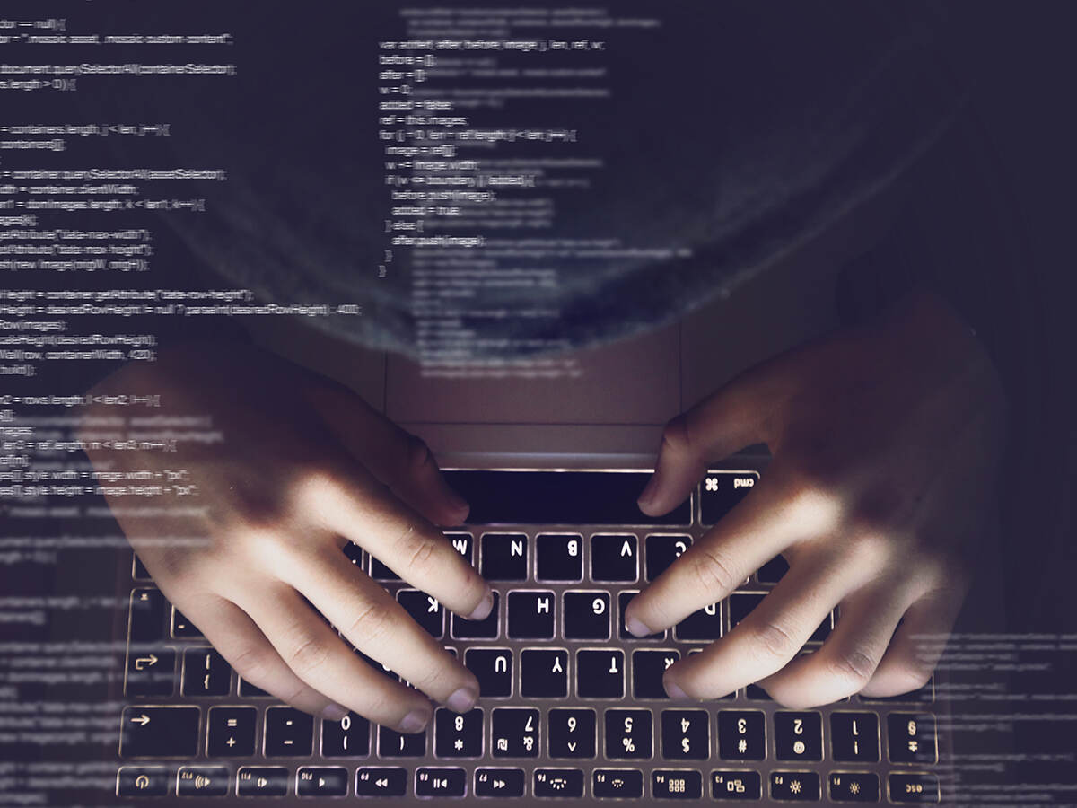 A person typing on a laptop