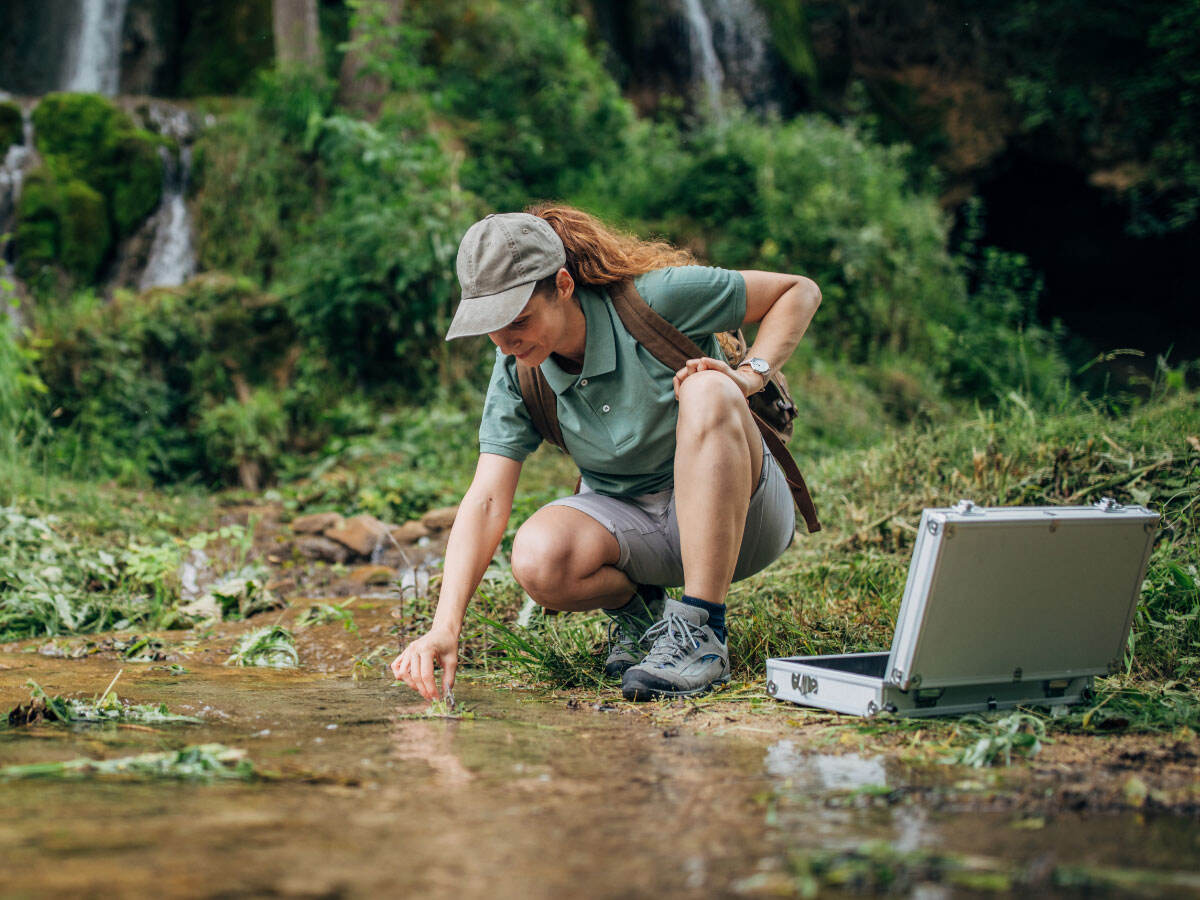 Biological Researcher Taking a Water Sample