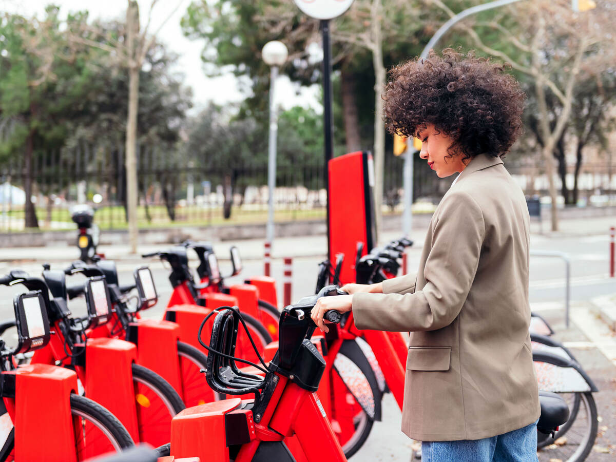 Person renting an e-bike near a park