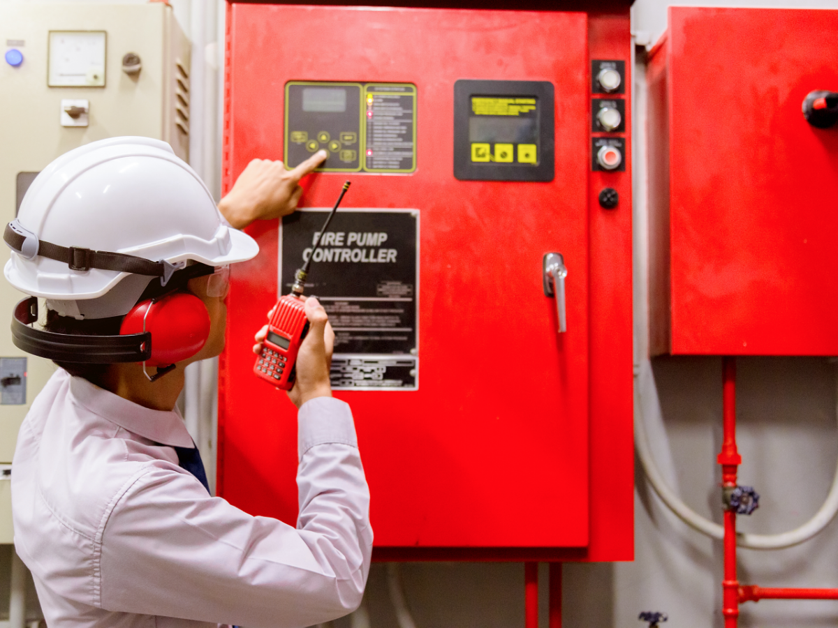 person in hard hat testing fire control system