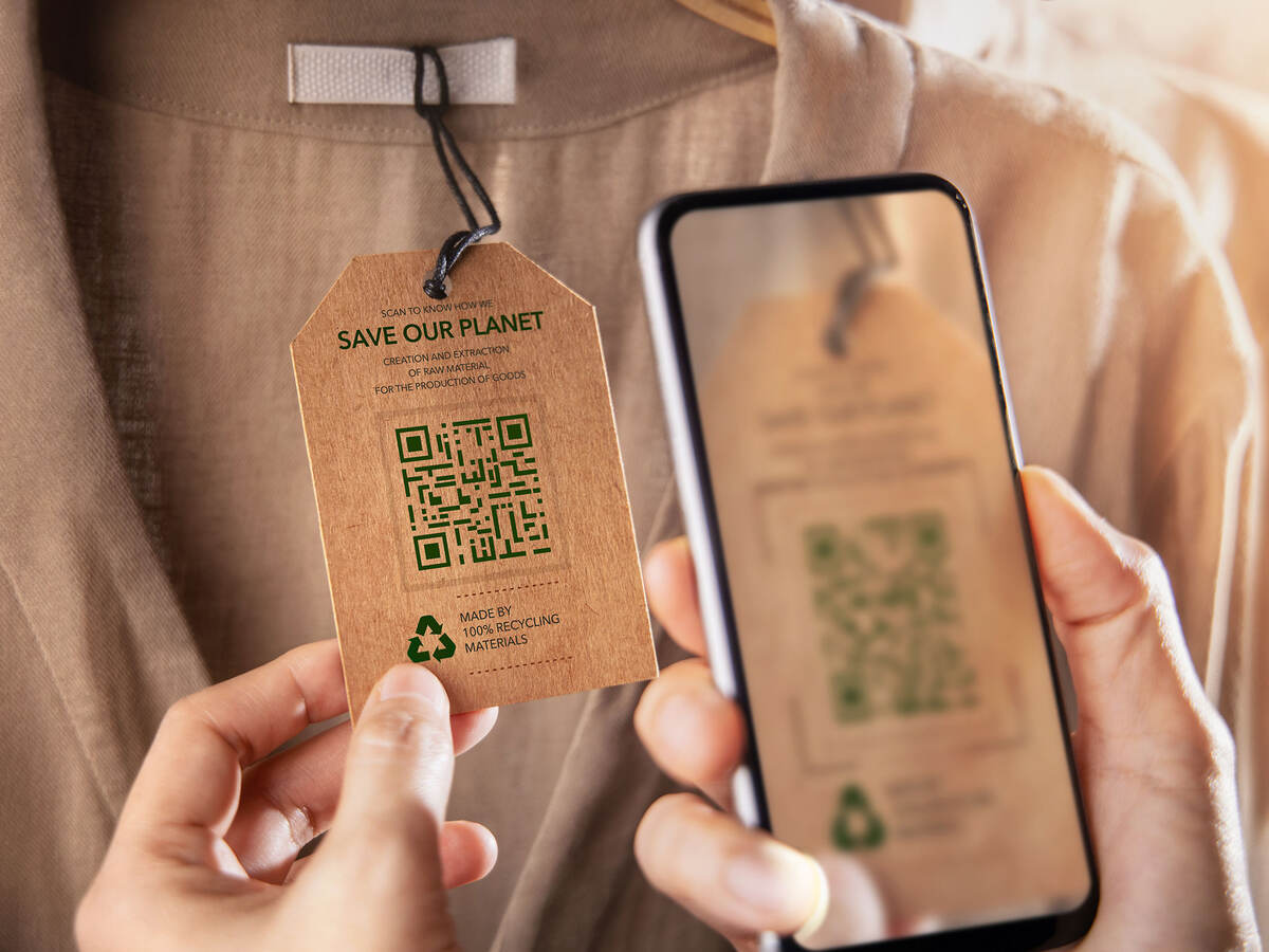 A person checking a clothing tag QR code