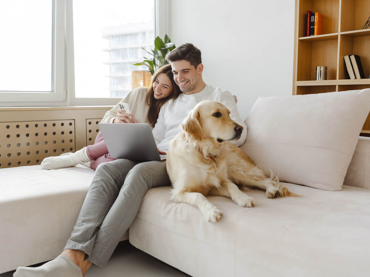 A couple and their dog on the sofa